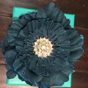 Empty Tieks box with navy blue flower.